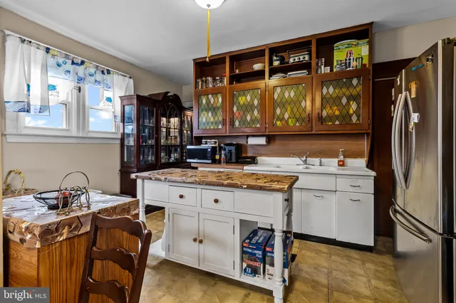 a kitchen with a sink stove and refrigerator