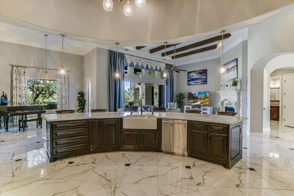 a large kitchen with stainless steel appliances and a large counter top oven