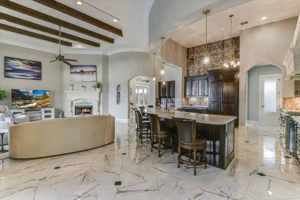 a living room with fireplace furniture and a chandelier