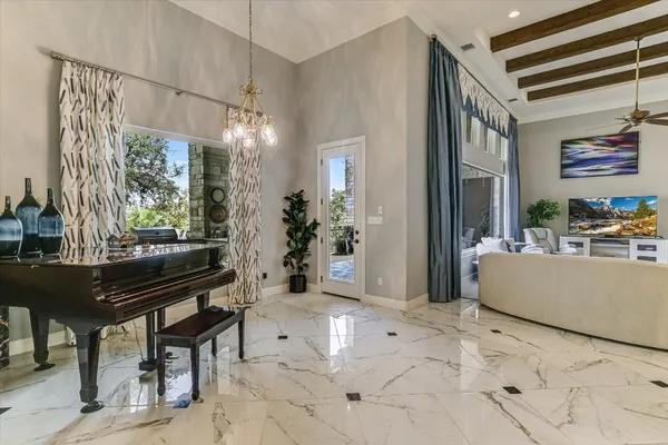 a living room with furniture and a chandelier