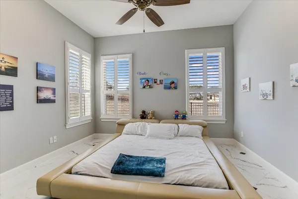 a bedroom with a large bed and a window