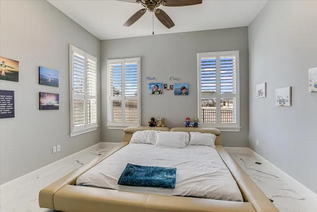 a bedroom with a large bed and a window