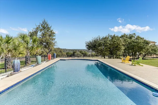 a view of a swimming pool with an outdoor seating