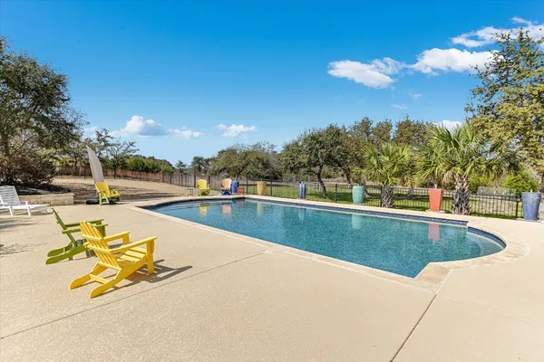 a view of swimming pool with outdoor seating