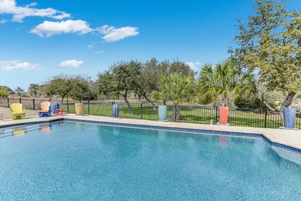 a view of a house with pool and a yard