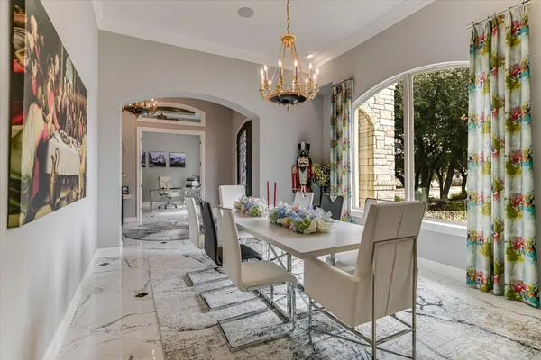 a view of a dining room with furniture a chandelier and wooden floor