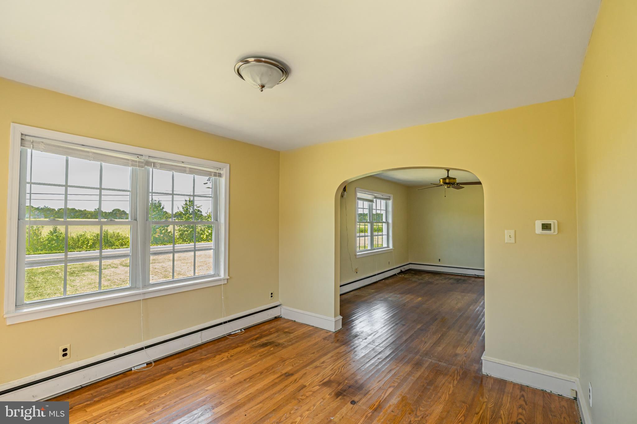 16 East Factory Road Berlin, NJ 08009 - Photo 2 of 13 a view of an empty room with a window and wooden floor