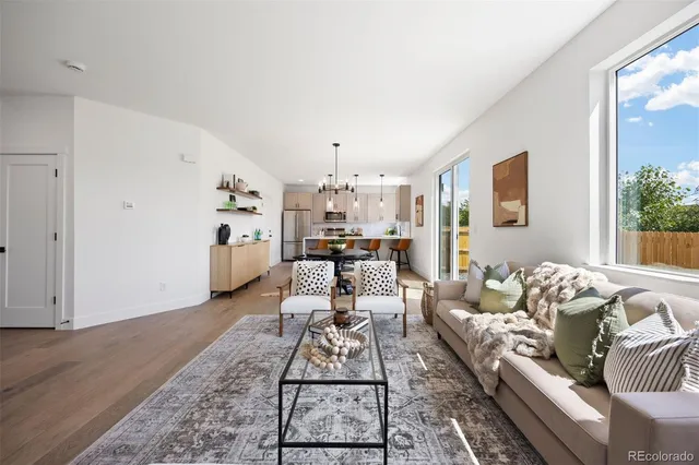 a living room with furniture and wooden floor