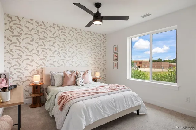 a bedroom with a bed and a window