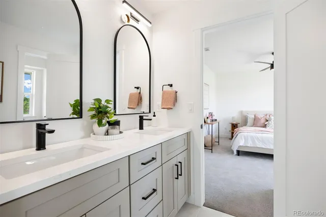 a en suite bathroom with double sink and a mirror