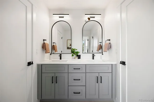 a bathroom with a double vanity sink and a mirror