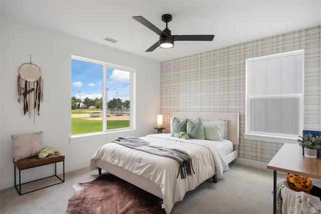 a bedroom with a bed a couch and a window