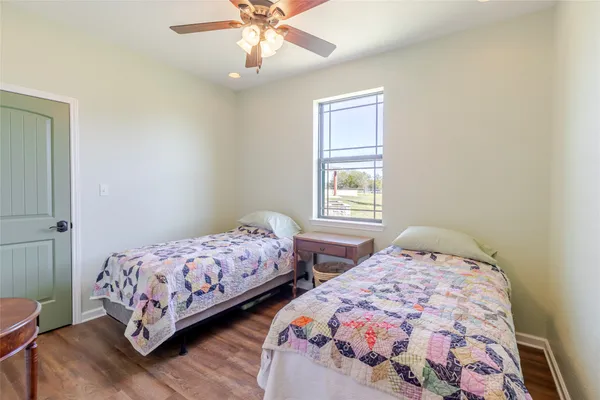 a bedroom with two beds and a window