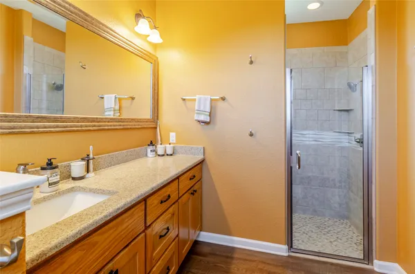 a bathroom with a granite countertop sink and a mirror