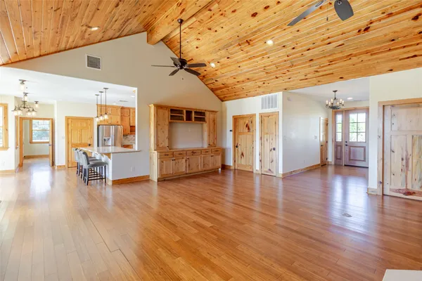 a view of a livingroom with furniture wooden floor and front door