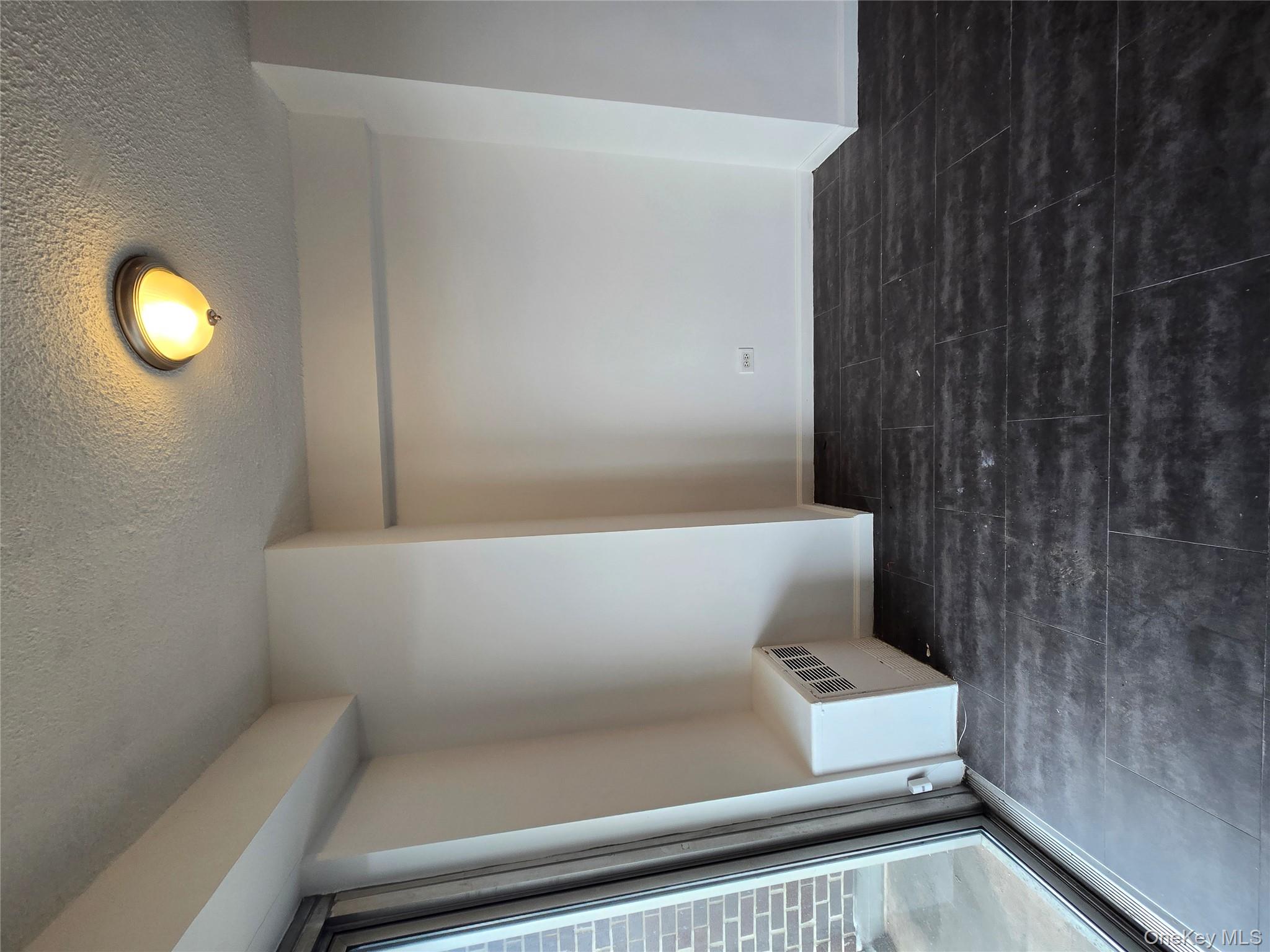 34-12 113th Street, Unit 8G Queens, NY 11368 - Photo 9 of 13 a view of an empty room with wooden floor and a window