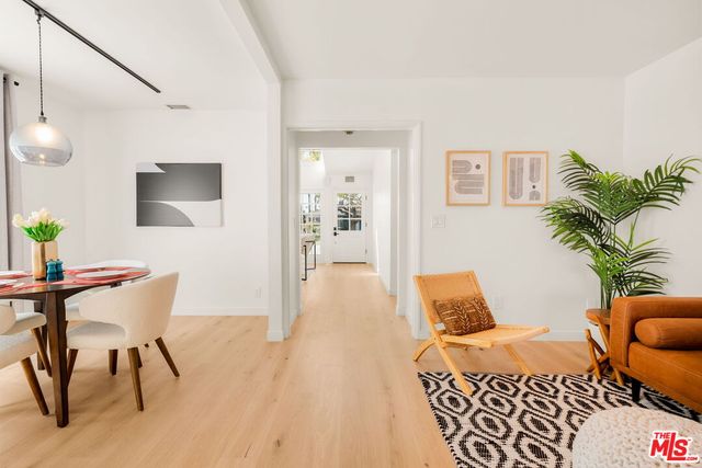 a bedroom with furniture and a wooden floor