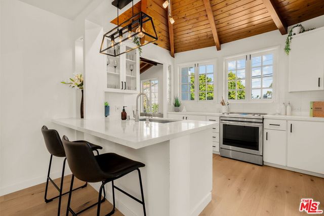 a kitchen with a stove and white cabinets