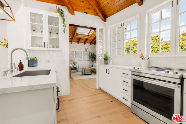 a kitchen with stainless steel appliances a stove sink and cabinets