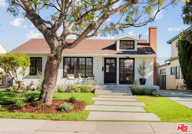 a front view of a house with a yard table and chairs