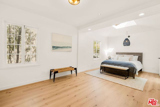 a bedroom with a bed and a chair