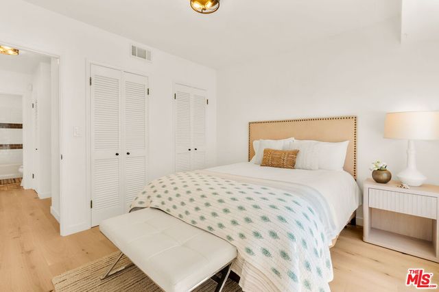 a bedroom with a bed and a lamp