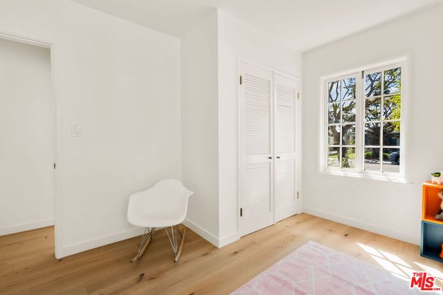 a view of a livingroom with wooden floor and a potted plant