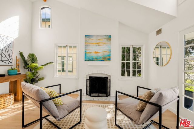 a living room with furniture a rug and a fireplace