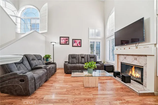 a living room with furniture fireplace and flat screen tv