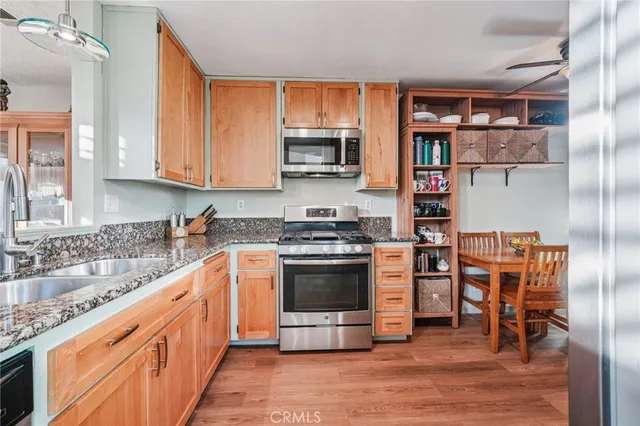 a kitchen with stainless steel appliances granite countertop a stove and a refrigerator