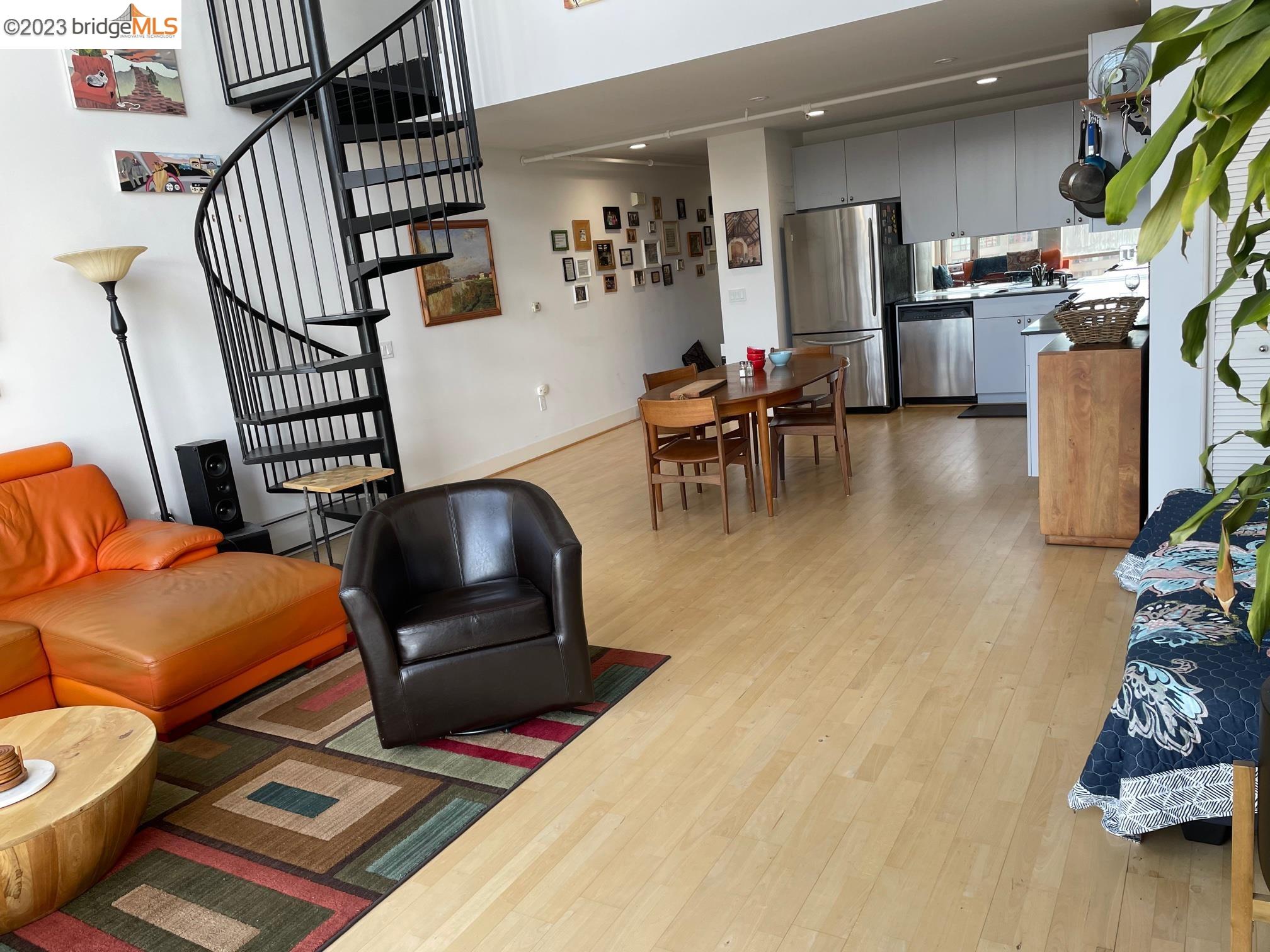 311 Oak Street, Unit PH27 Oakland, CA 94607 - Photo 5 of 21 a living room with furniture and a wooden floor