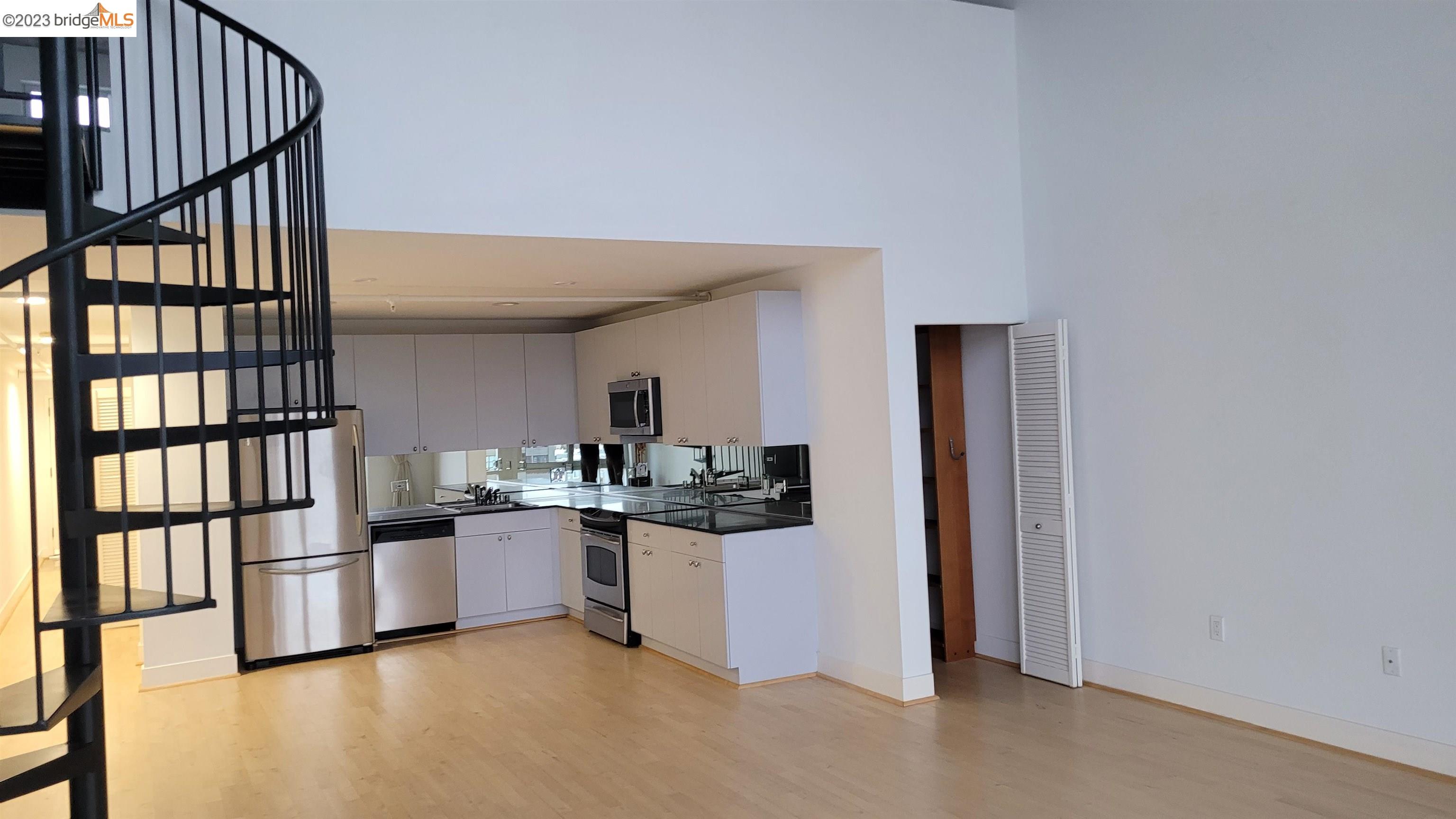 311 Oak Street, Unit PH27 Oakland, CA 94607 - Photo 7 of 21 a kitchen with stainless steel appliances granite countertop a stove and cabinets