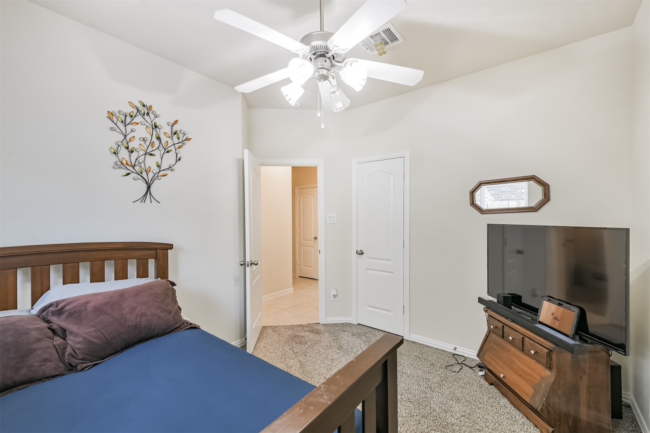 7527 Windsor Valley Lane Houston, TX 77049 - Photo 32 of 35 a bedroom with a bed and a flat screen tv