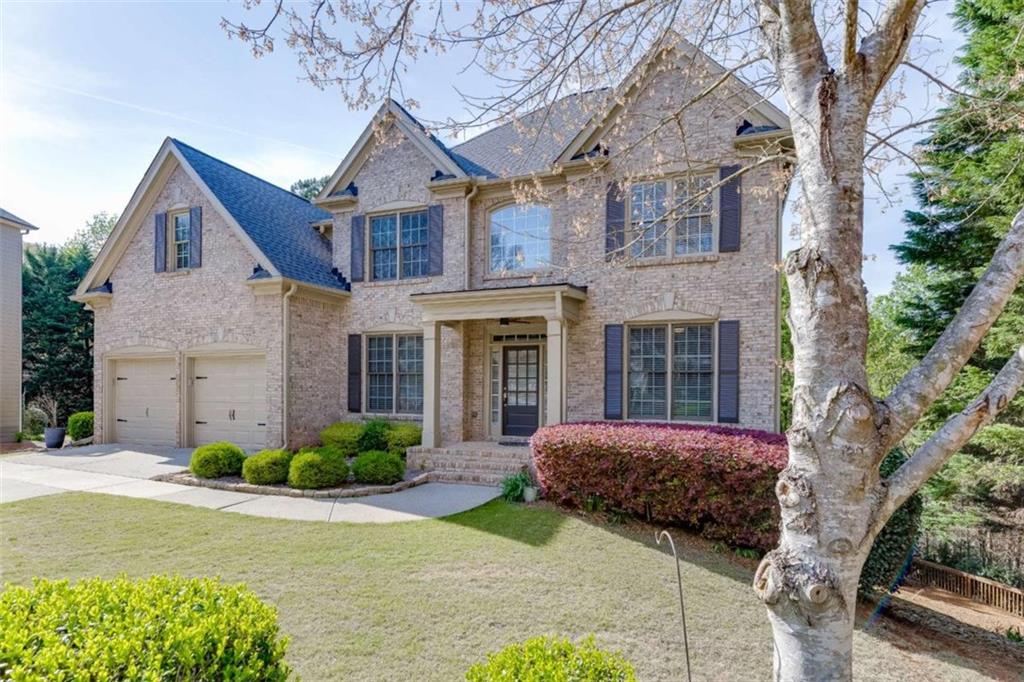 4880 Stone Moss Path Hoschton, GA 30548 - Photo 2 of 66 a front view of a house with garden