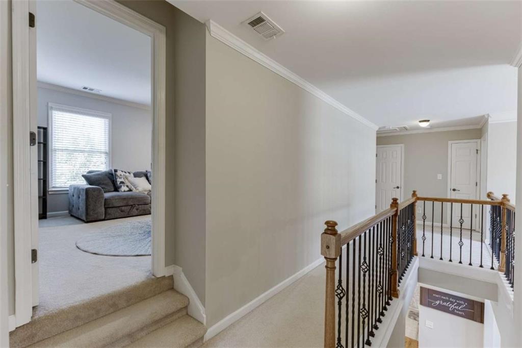 4880 Stone Moss Path Hoschton, GA 30548 - Photo 26 of 66 a view of a hallway to a livingroom and a hallway