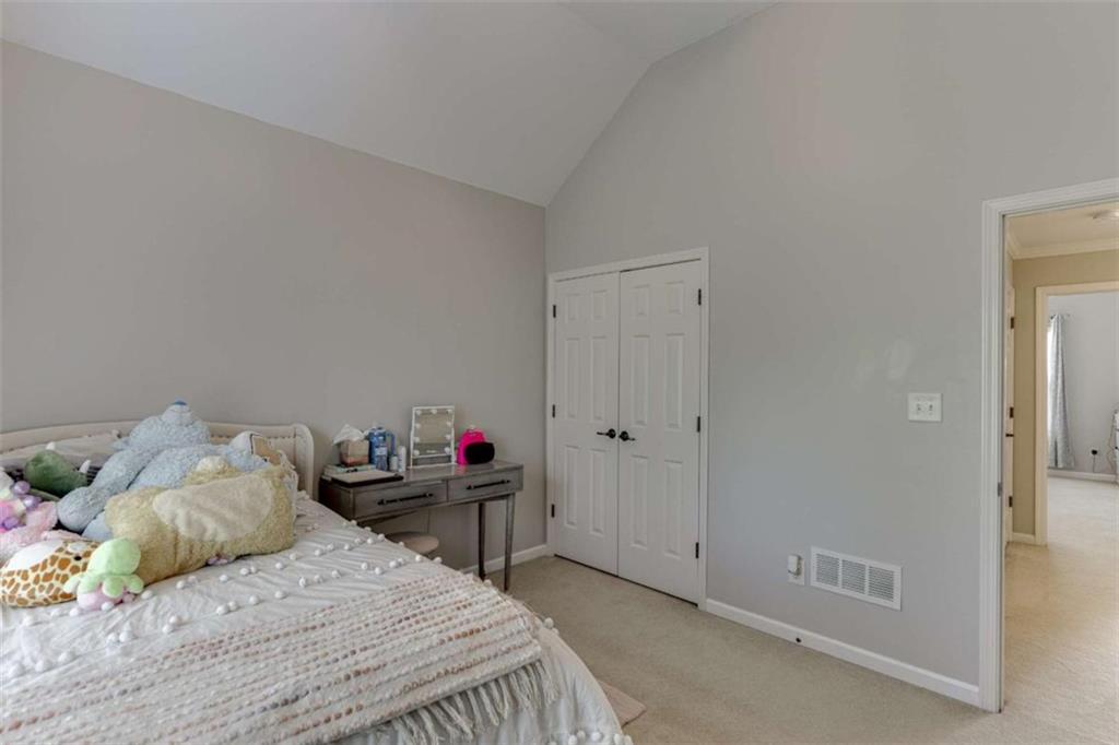 4880 Stone Moss Path Hoschton, GA 30548 - Photo 31 of 66 a bedroom with a bed and a closet