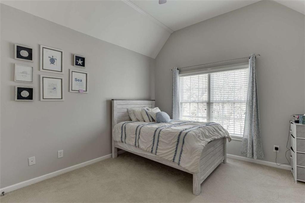 4880 Stone Moss Path Hoschton, GA 30548 - Photo 33 of 66 a bed room with a bed and a window