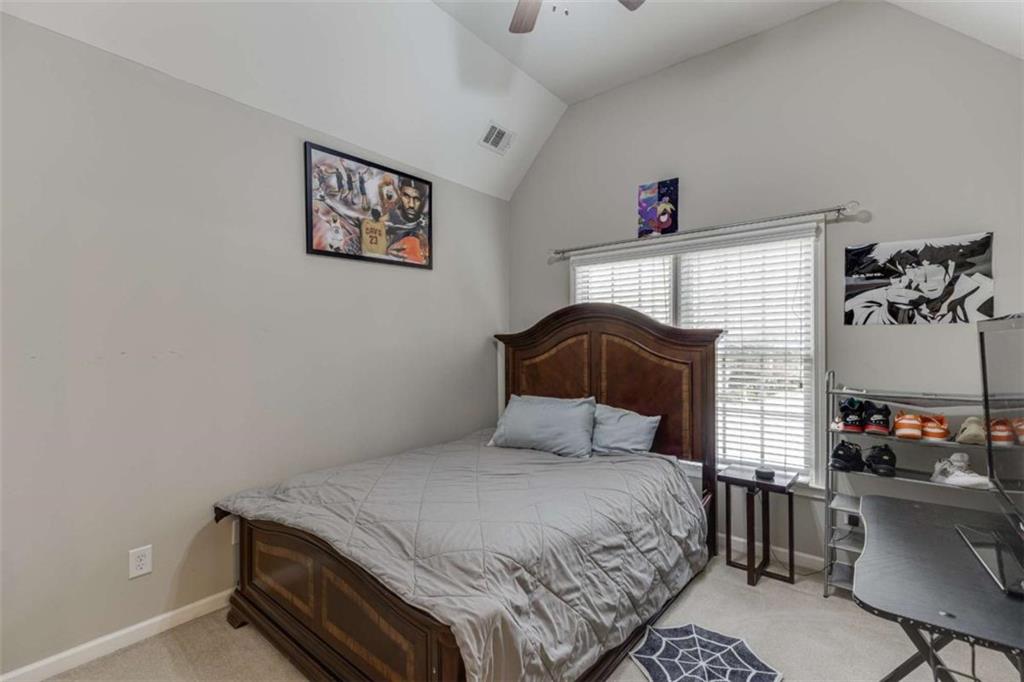 4880 Stone Moss Path Hoschton, GA 30548 - Photo 35 of 66 a bedroom with a bed and a potted plant on the dresser