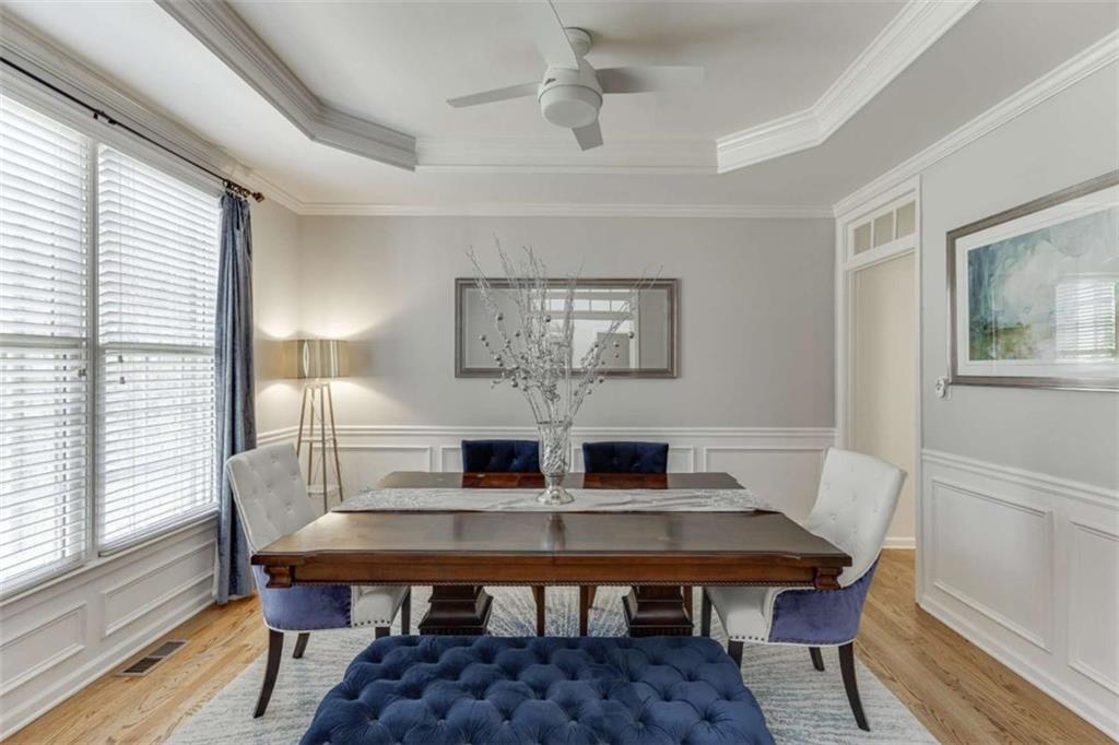 4880 Stone Moss Path Hoschton, GA 30548 - Photo 4 of 66 a view of a dining room with furniture and wooden floor