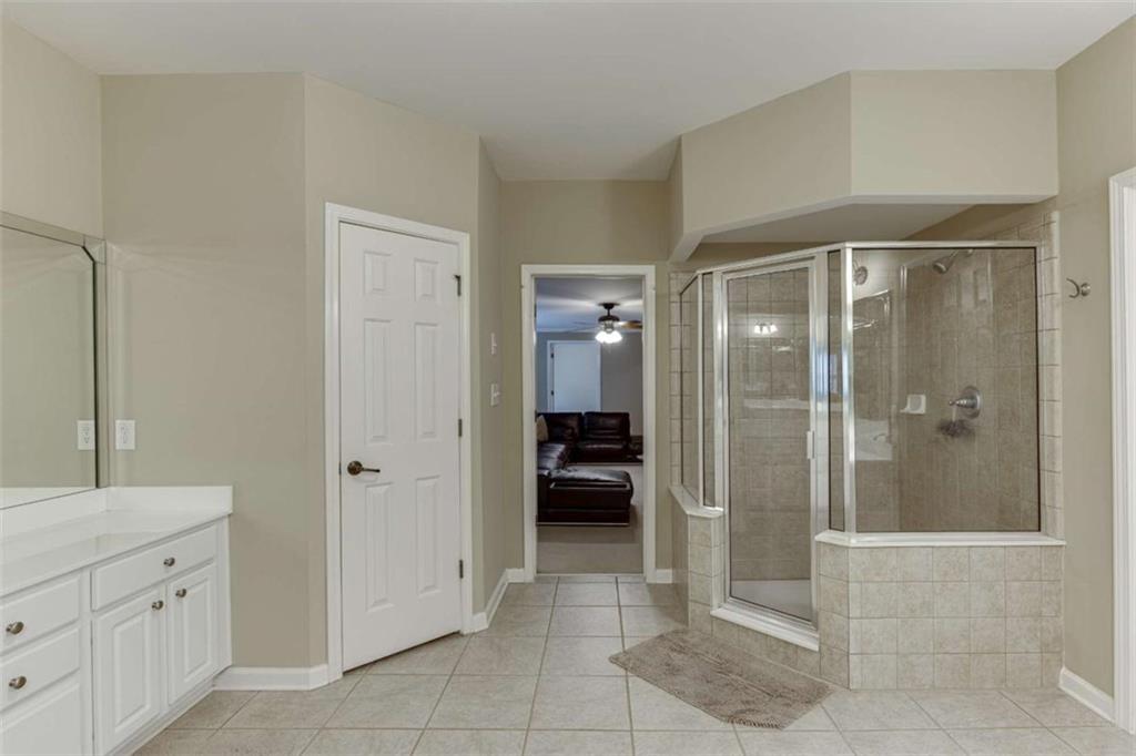 4880 Stone Moss Path Hoschton, GA 30548 - Photo 43 of 66 a bathroom with a shower and a sink