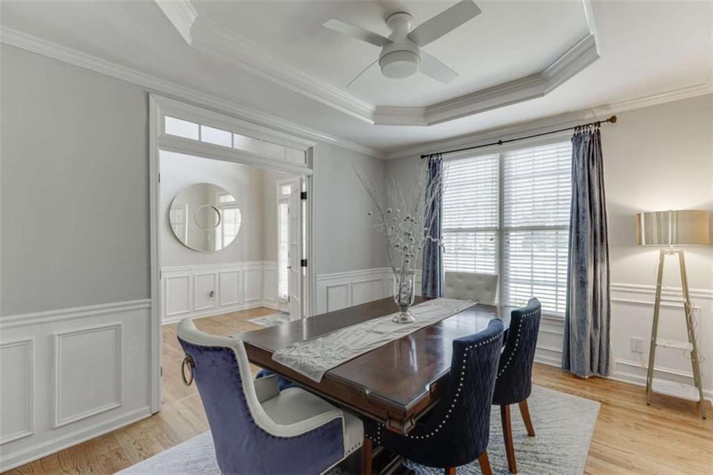 4880 Stone Moss Path Hoschton, GA 30548 - Photo 5 of 66 a view of a dining room with furniture window and wooden floor