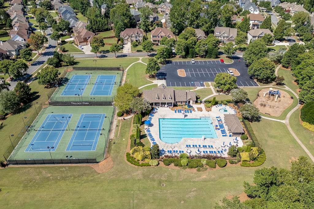 4880 Stone Moss Path Hoschton, GA 30548 - Photo 65 of 66 an aerial view of a house with a swimming pool