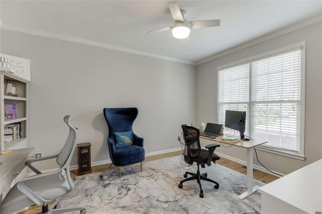 4880 Stone Moss Path Hoschton, GA 30548 - Photo 7 of 66 a view of a workspace with furniture and a window