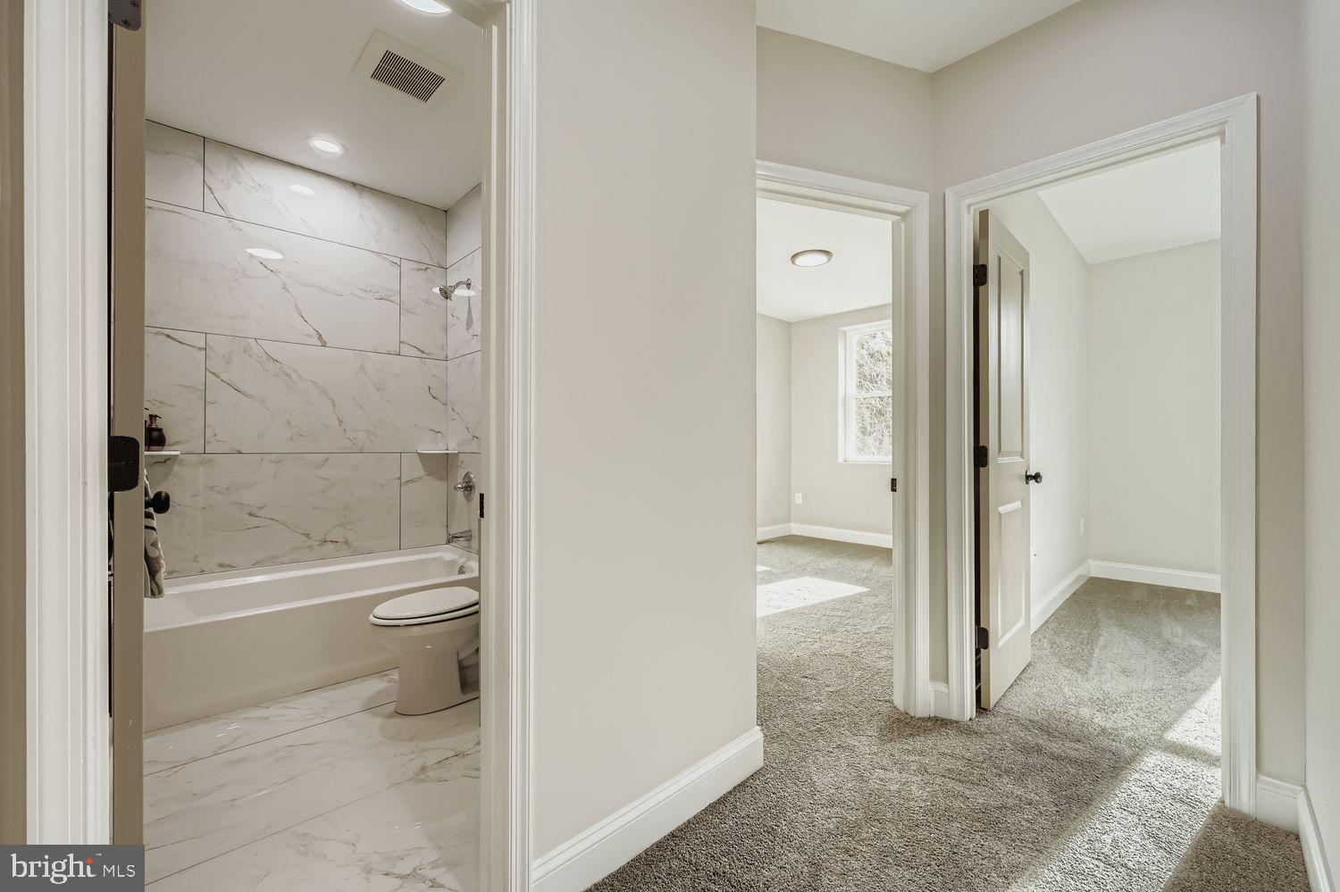 4119 Fairview Avenue Baltimore, MD 21216 - Photo 19 of 25 a bathroom with a granite countertop toilet a sink and bathtub