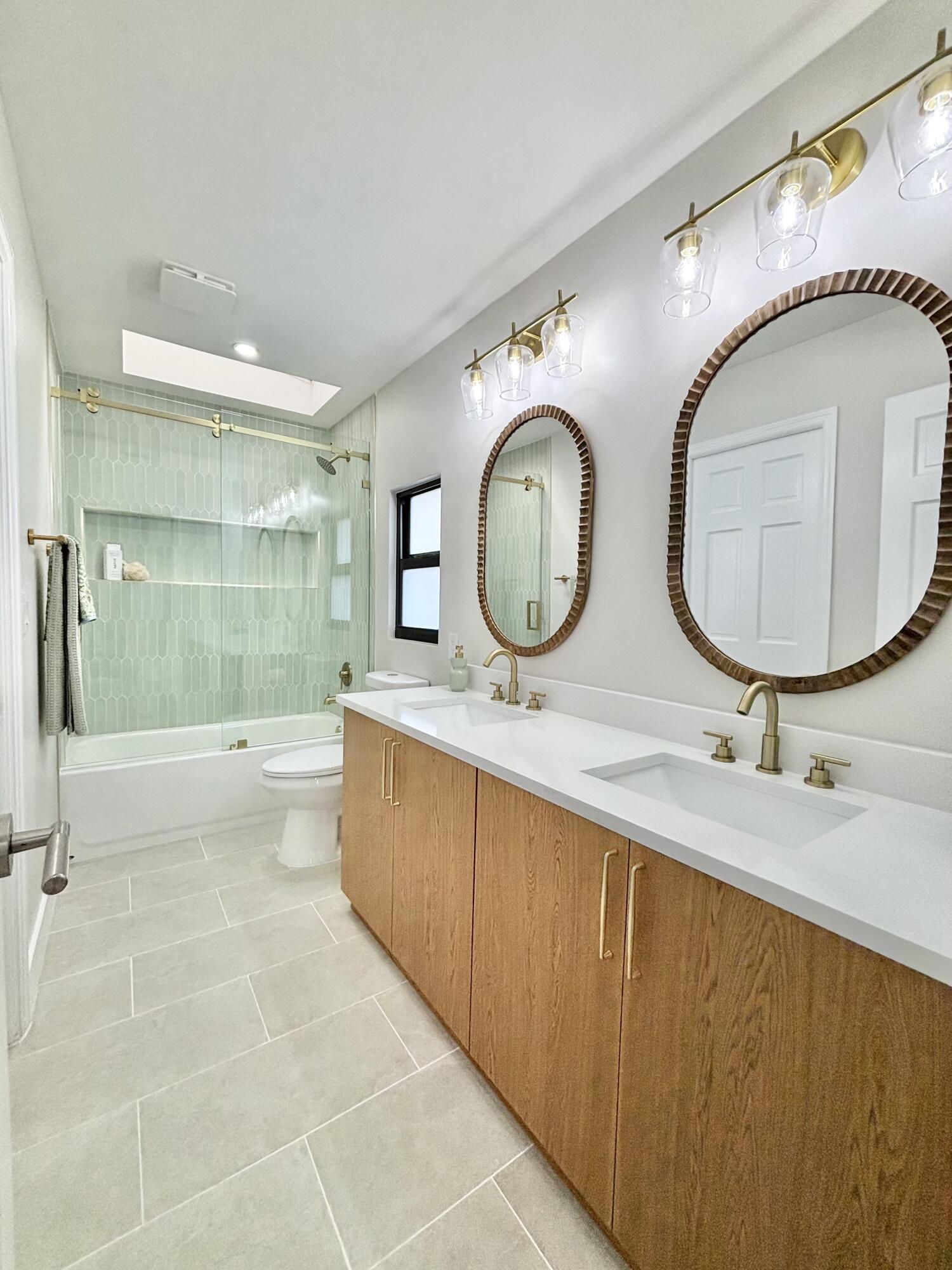 14 Southeast Paddock Circle Jupiter, FL 33469 - Photo 18 of 45 a bathroom with a toilet a sink and a mirror