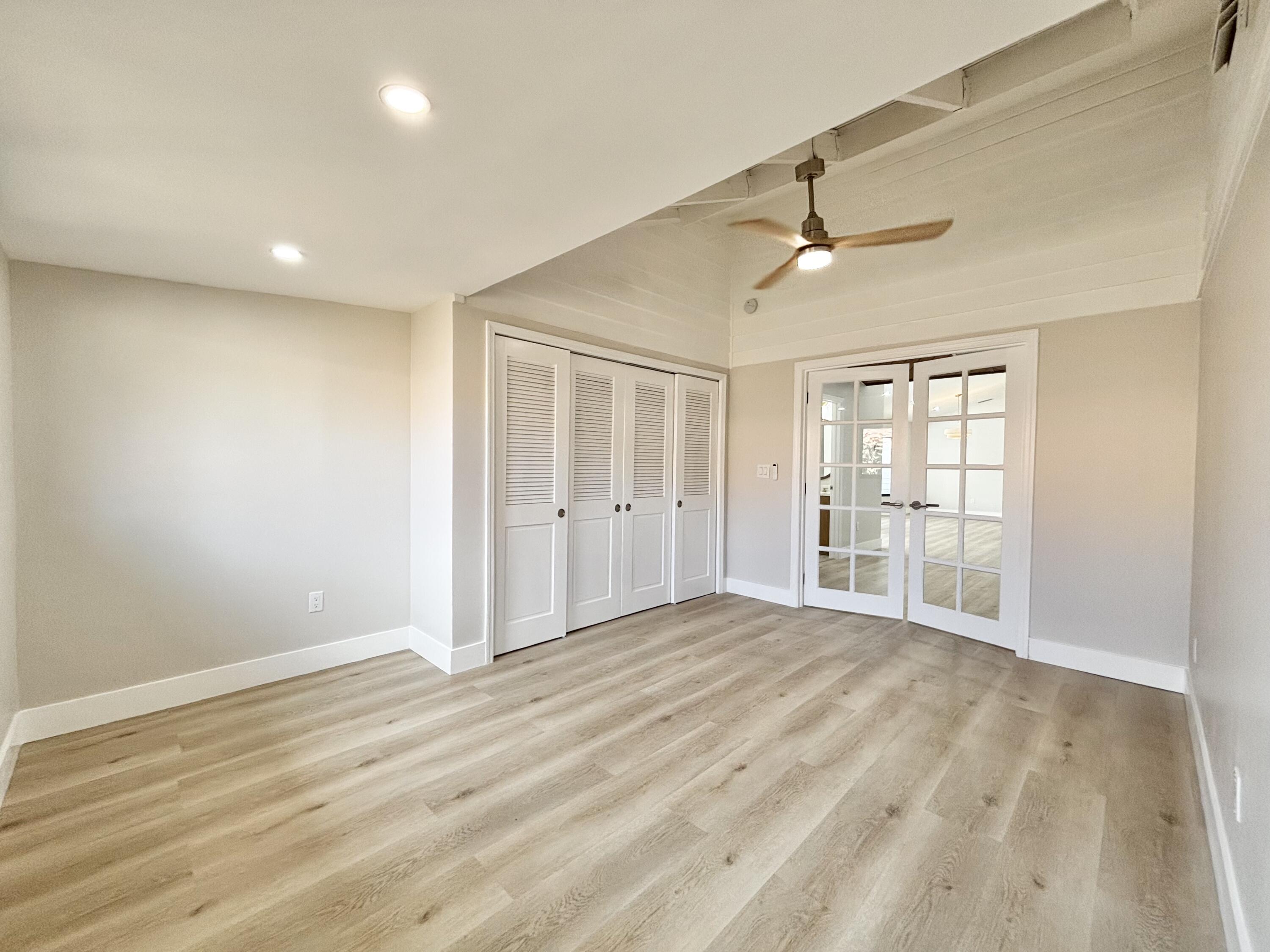 14 Southeast Paddock Circle Jupiter, FL 33469 - Photo 23 of 45 a view of an empty room with wooden floor and a window
