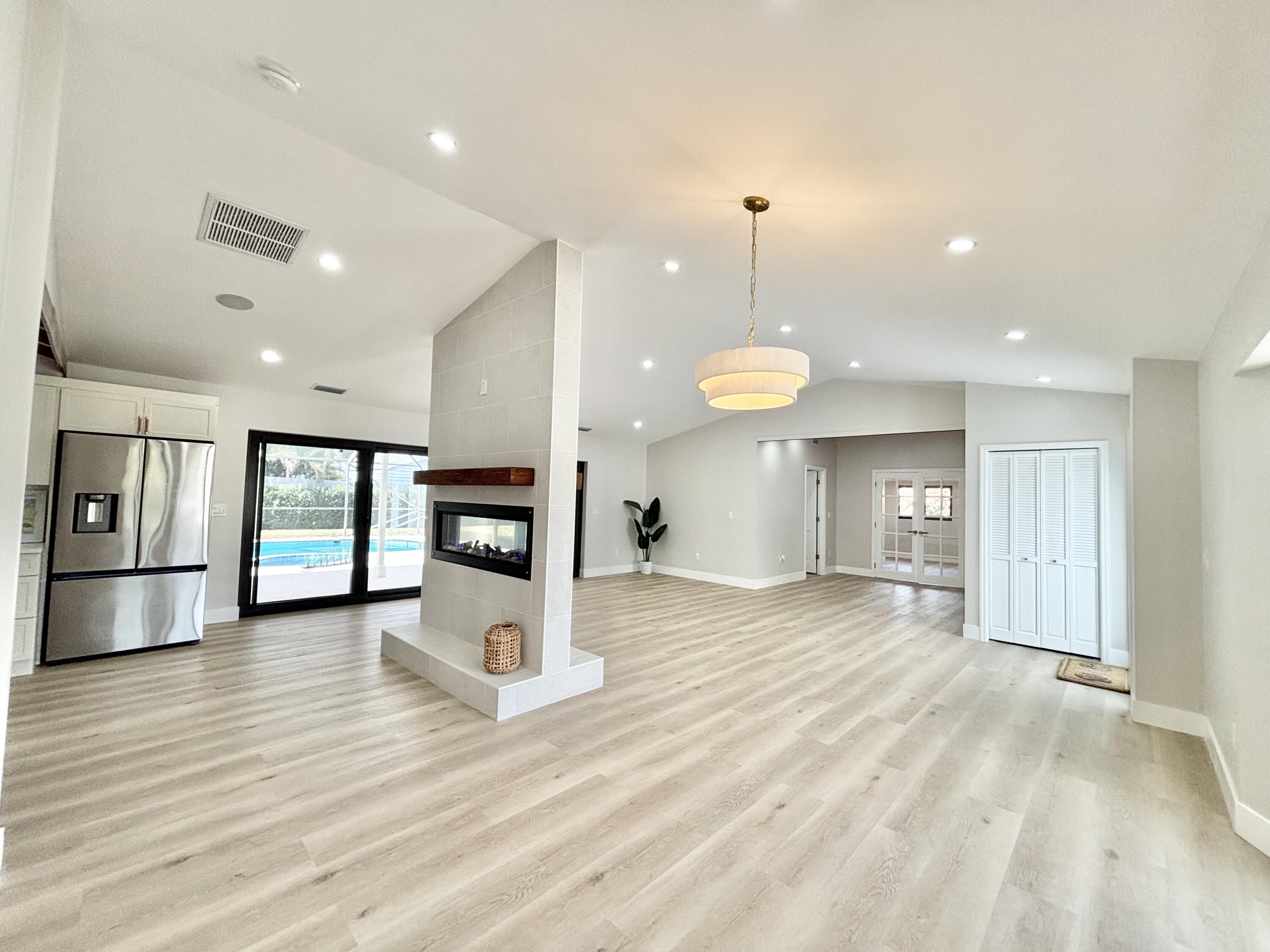 14 Southeast Paddock Circle Jupiter, FL 33469 - Photo 3 of 45 a view of a kitchen with a sink and a large window