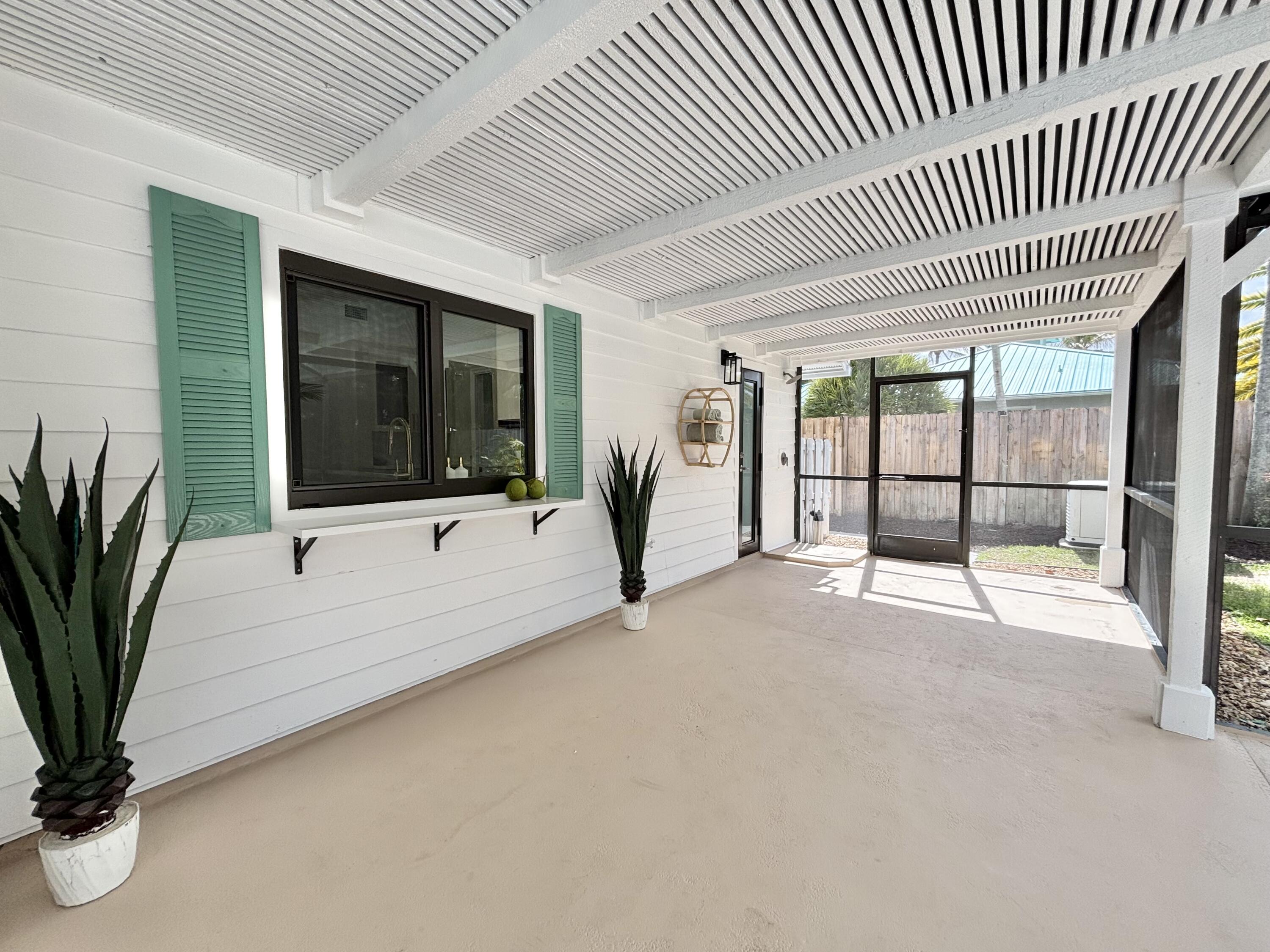 14 Southeast Paddock Circle Jupiter, FL 33469 - Photo 31 of 45 a view of a livingroom with a large window and couch