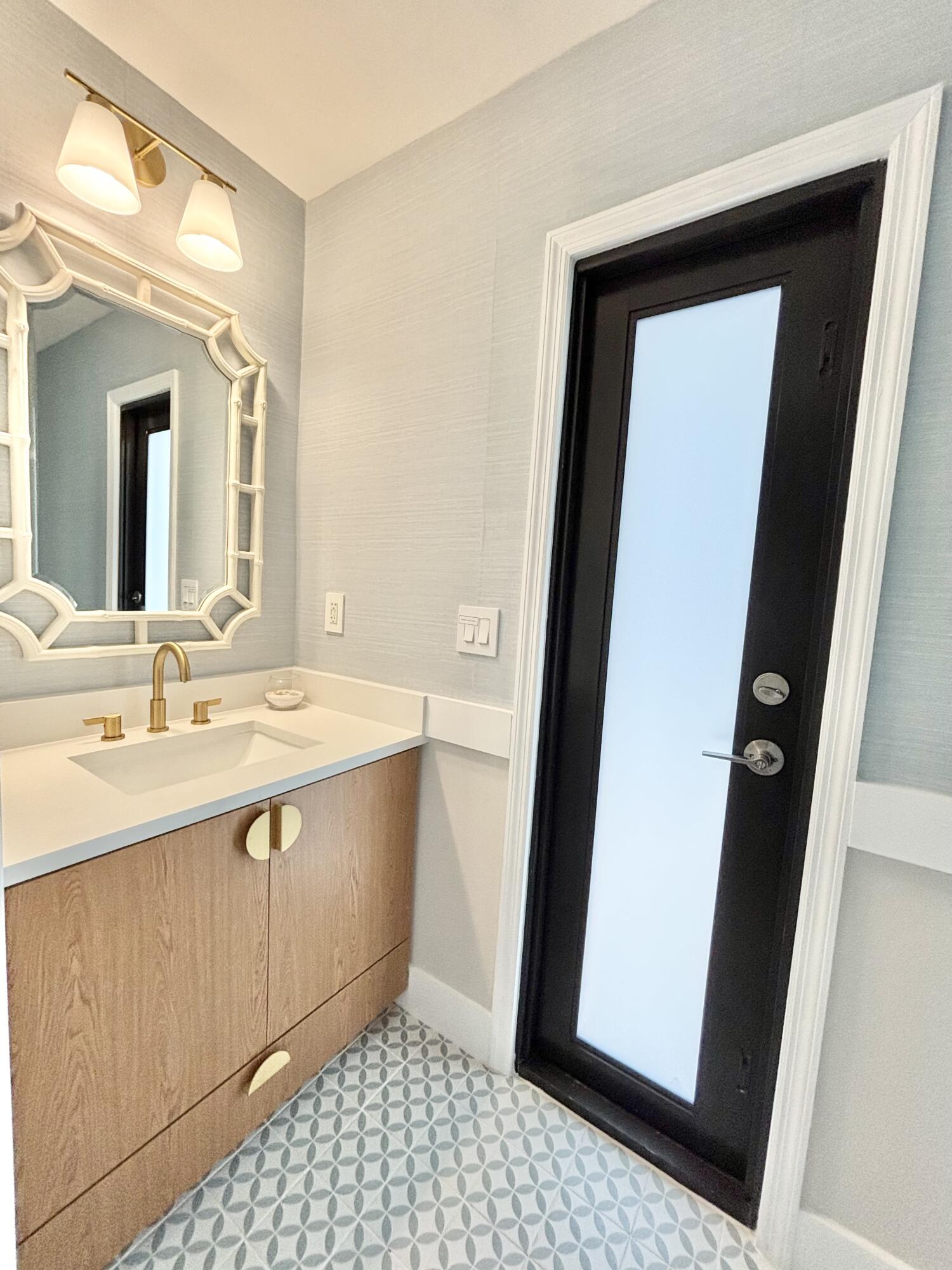 14 Southeast Paddock Circle Jupiter, FL 33469 - Photo 33 of 45 a bathroom with a sink a mirror and a shower