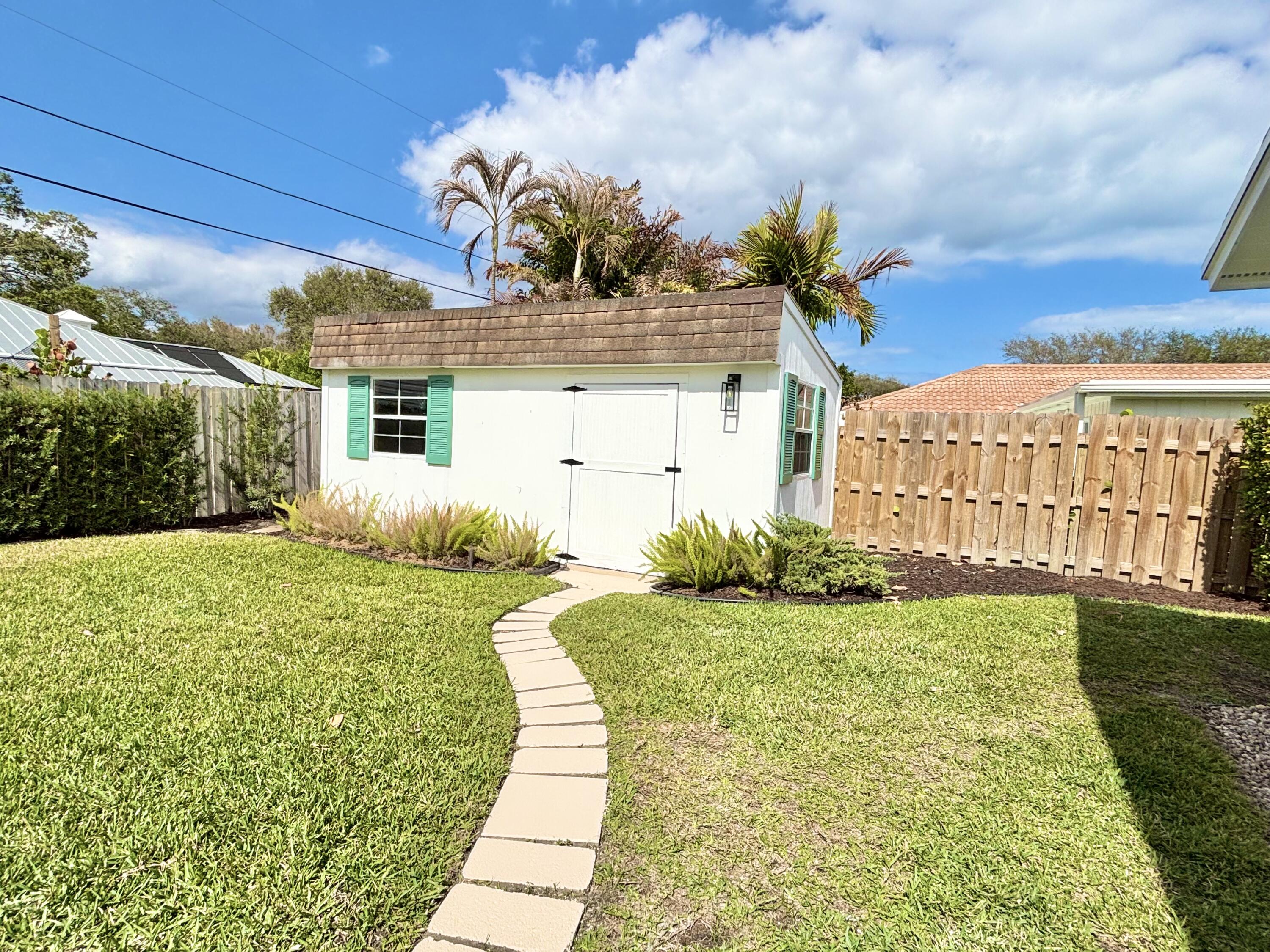 14 Southeast Paddock Circle Jupiter, FL 33469 - Photo 38 of 45 a view of a house with a yard